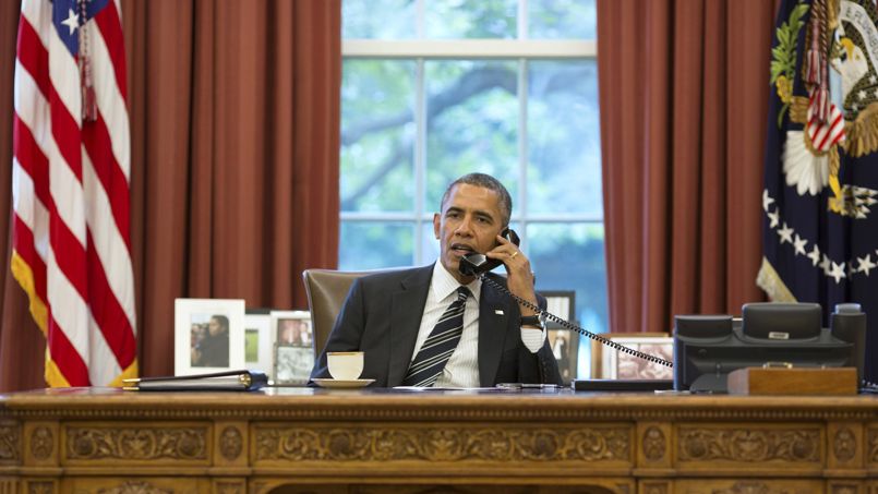 U.S. President Obama talks on the phone with Iranian President Rouhani in the Oval Office at the White House in Washington